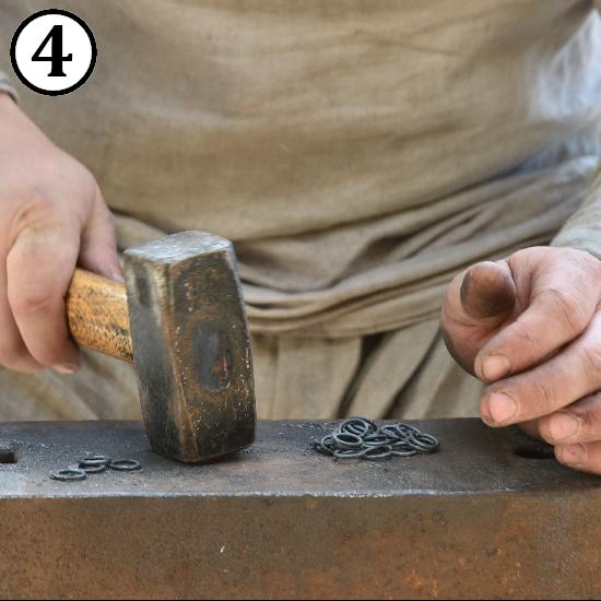 Striking rings by hammer to make them flat for making riveted chainmail rings.